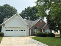 Charming single-Gathering home with well-maintained lawn and two car garage at 3718 Jackson Bluff Dr, Lawrenceville, GA 30044