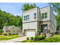 Beautiful two-story home featuring a stone and siding exterior, a driveway, and a one-car garage at 2020 Bixby Se St, Atlanta, GA 30317
