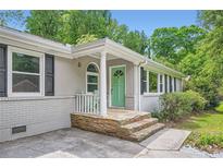 Charming single-story home featuring a stone-accented porch and a brightly colored front door at 2205 Desmond Dr, Decatur, GA 30033