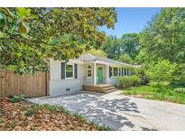 Charming brick home with a bright green front door and a well-maintained front yard at 2205 Desmond Dr, Decatur, GA 30033