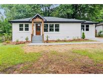 Charming renovated home with a modern painted brick exterior, updated landscaping, and a welcoming front porch at 2244 Alpha Dr, Decatur, GA 30032