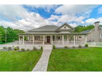 Charming home with a large wrap-around porch, walkway, well-manicured lawn and picturesque curb appeal at 4527 Dallas St, Acworth, GA 30101