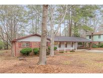 Charming single-story home featuring a brick facade, covered carport, and inviting curb appeal at 50 Carriage Trce, Stockbridge, GA 30281