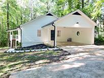 Charming home with an open carport, fresh landscaping, and a stairway leading to a side entrance at 336 Shady Lane Cir, Canton, GA 30115