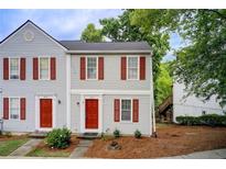 Charming two-story townhome with red shutters and a well-maintained lawn at 3999 Bayside Cir, Doraville, GA 30340