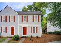 Charming two-story home with red shutters, well-maintained landscaping and inviting curb appeal at 3999 Bayside Cir, Doraville, GA 30340