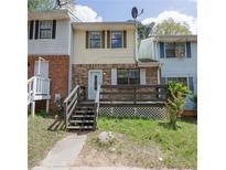 Charming townhome with a brick facade and a cozy front deck at 6991 Flagstone Dr, Austell, GA 30168