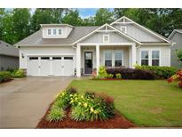 Charming single Gathering home with a lush front yard and a two-car garage at 219 Cordova St, Woodstock, GA 30189