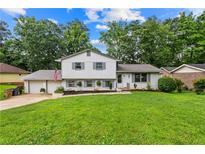 Charming two-story home featuring a lush front lawn and attached garage at 6628 Londonderry Dr, Morrow, GA 30260