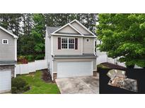 Two-story home with a one car garage and a well-maintained lawn at 176 Silver Fox Trl, Dallas, GA 30157