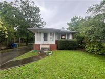 Charming single-story home with a brick foundation and landscaped front yard at 301 Sisson Ne Ave, Atlanta, GA 30317