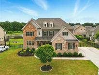 Stunning two-story home featuring brick and stone accents, lush landscaping, and a well-manicured lawn at 847 Rolling Hill, Kennesaw, GA 30152