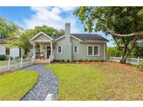Charming single-story home with a manicured lawn, inviting entrance, and classic architectural details at 67 Trammell Sw St, Marietta, GA 30064