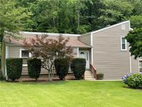 Cozy one-story home with manicured front lawn and mature trees for added privacy at 3100 Karen Ne Ln, Marietta, GA 30062