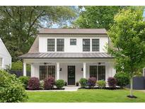 Charming two-story home with a well-manicured lawn and inviting front porch at 313 Sisson Ne Ave, Atlanta, GA 30317