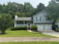 Charming two-story home with a well-manicured lawn and a two-car garage at 109 Ivy Crest Dr, Dallas, GA 30157