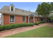 Charming brick home featuring a well-manicured front yard and traditional architectural details at 460 Chowning Nw Pl, Marietta, GA 30064