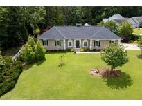 Charming home with lush green lawn and mature trees at 2265 Colony Dr, Canton, GA 30114