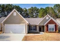 Charming single-story home with a two-car garage, brick accent and manicured lawn at 2350 Laurel Pointe Ln, Lawrenceville, GA 30043