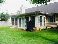 Cozy sunroom featuring multiple windows for great natural light plus a door to the backyard at 2350 Laurel Pointe Ln, Lawrenceville, GA 30043