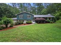 Charming two-story home with green lawn, classic shutters and beautiful, mature landscaping at 2240 Murdock Rd, Marietta, GA 30062