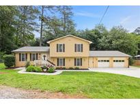 Charming two-story home with a well-manicured lawn, attractive landscaping, and an attached two-car garage at 423 Mephisto Cir, Lawrenceville, GA 30046