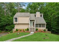 Charming home with a well-manicured lawn, stone accents and mature trees at 1720 Little Willeo Rd, Marietta, GA 30068
