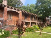 Charming brick building featuring lush landscaping, multiple entryways, and beautiful architectural details at 3117 Colonial Way # G, Atlanta, GA 30341