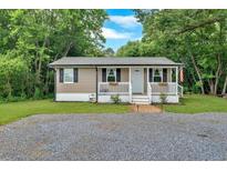 Charming single-story home features neutral siding, black shutters, and a welcoming front porch at 104 Gilreath Rd, Cartersville, GA 30121