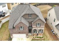 Beautiful two-story home featuring brick and stone accents, a two-car garage, and professionally landscaped front yard at 366 Highbranch Cir, Lawrenceville, GA 30044