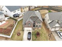 Inviting two-story home with a brick and stone facade, attached garage, and well-manicured front yard at 366 Highbranch Cir, Lawrenceville, GA 30044