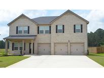 Charming brick home featuring a spacious three car garage and a well-manicured front lawn at 1612 Fuma Leaf Way, Mcdonough, GA 30253