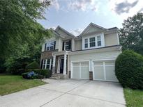 Inviting two-story home featuring a two-car garage and beautiful landscaping at 944 Reap Ln, Lawrenceville, GA 30043
