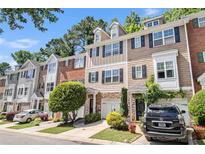 Charming townhomes featuring varied brick and siding with attached garages and manicured landscaping at 3068 Lauren Parc Rd, Decatur, GA 30032