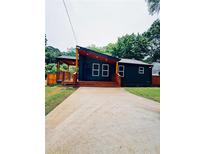 Charming home with a modern design, featuring a covered porch and well-manicured lawn at 2228 Carey Se Dr, Atlanta, GA 30315