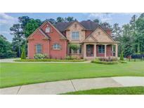 Beautiful brick and stone home with lush lawn and manicured landscaping at 1283 Silver Trace Sw Dr, Lilburn, GA 30047