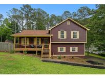 Charming two-story home featuring a cozy front porch and a well-maintained lawn at 35 Lady Morgan Ln, Dallas, GA 30157