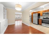 Bright dining area features hardwood floors, built-in cabinets and a view to the kitchen with stainless steel appliances at 2355 Henderson Mill Ne Rd # 6, Atlanta, GA 30345