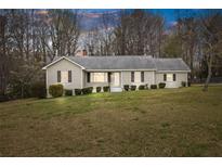 Charming single story home features a large front yard, neutral paint, and decorative shutters at 1312 Milstead Ave, Conyers, GA 30012