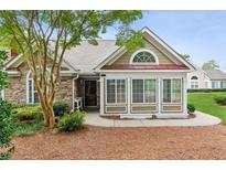 Charming home exterior featuring stone accents, large windows, and lush landscaping at 6107 Malloway Ct # B-6107, Cumming, GA 30041