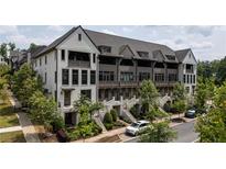 Charming townhome with beautiful landscaping, multiple stories, and a welcoming curb appeal at 6613 Encore Blvd, Atlanta, GA 30328