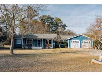 Charming blue single story home with a large yard and a two-car garage at 110 Fox Meadow Dr, Covington, GA 30016
