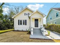 Charming home with freshly painted exterior, landscaped front yard, and inviting front porch at 1382 Elizabeth Ln, Atlanta, GA 30344