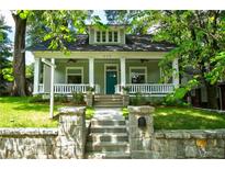 Charming home with a welcoming front porch, stone stairs, and lush green lawn at 630 Cleburne Ne Ter, Atlanta, GA 30306
