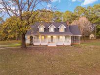 Charming one-story home with dormer windows and a cozy front porch at 935 Old Loganville Rd, Loganville, GA 30052