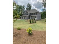 Charming two-story home with landscaped yard and traditional architectural details at 3030 Fairway Dr, Villa Rica, GA 30180