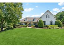 Beautifully landscaped front yard with a charming two-story home and lush greenery at 206 Savanna Estates Ct, Canton, GA 30115