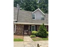 Charming brick townhouse featuring a well-maintained front entrance and landscaped bushes at 3117 Reeves Se St, Smyrna, GA 30080