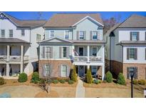 Charming two-story home with brick accents and a cozy front porch, nestled in a well-manicured neighborhood at 164 Inwood Walk, Woodstock, GA 30188