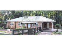Charming brick home with a metal roof and welcoming front gazebo at 2225 Harold Se Ln, Smyrna, GA 30080